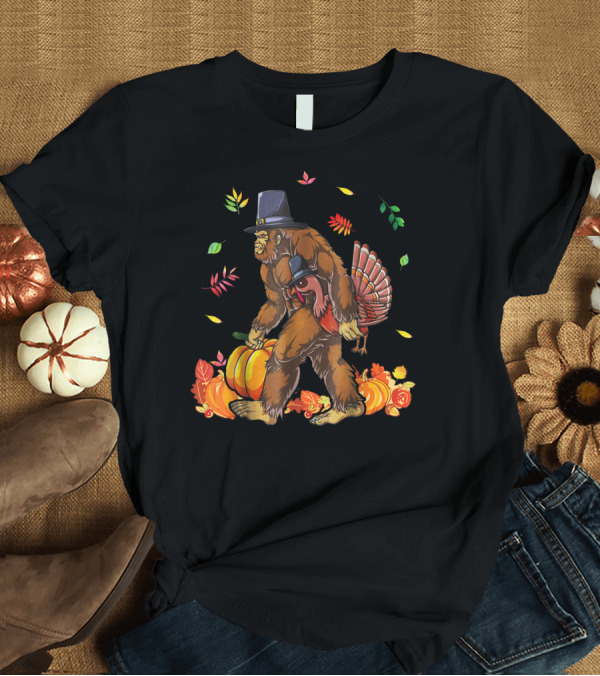 T-Shirt: Bigfoot Carrying Turkey with Pumpkin and Fall Leaves T-Shirt Bigfoot Carrying Turkey with Pumpkin and Fall Leaves T-Shirt