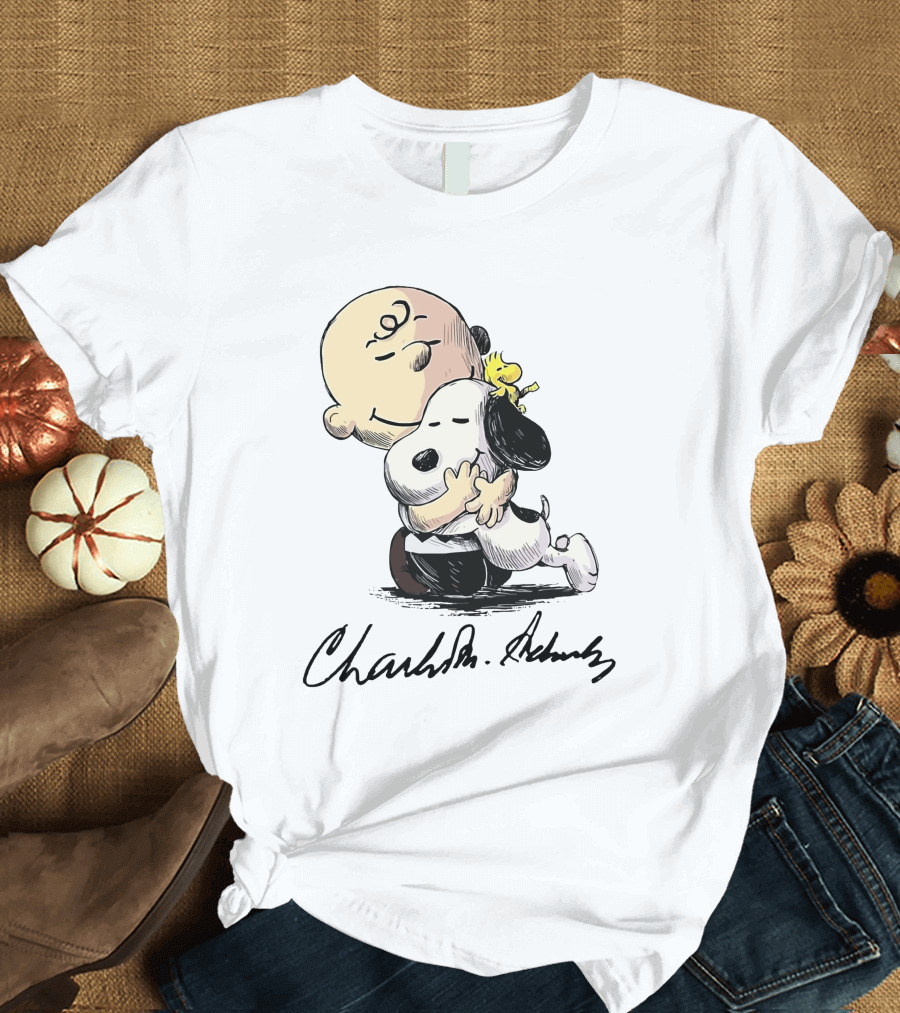 Snoopy and Charlie Brown Hugging by Charles M. Schulz T-Shirt