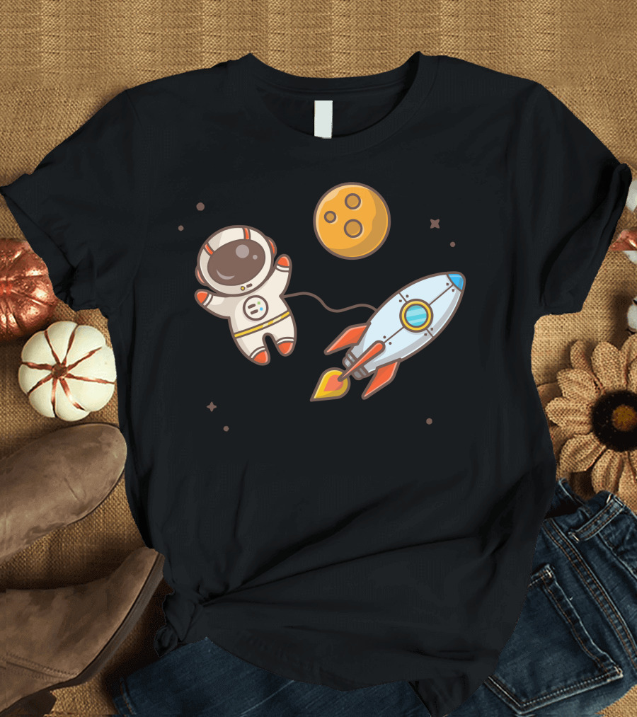 Cute Astronaut Floating Beside Rocket and Moon in Space Adventure T-Shirt