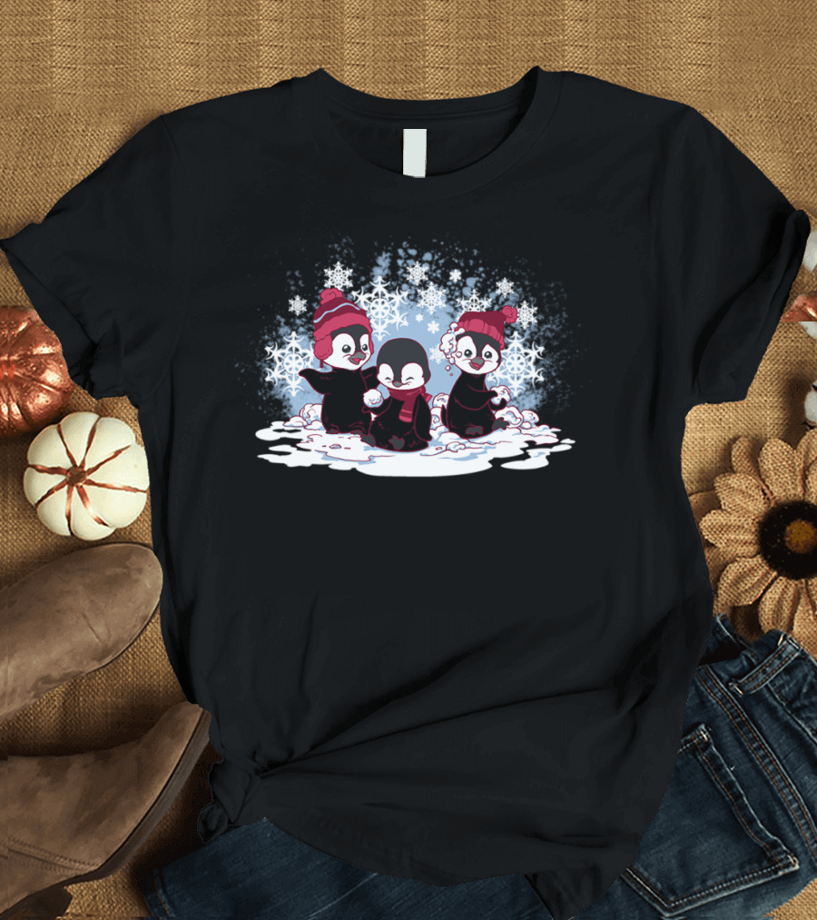 Playful Snow Penguins in Red Winter Hats Surrounded by Snowflakes T-Shirt