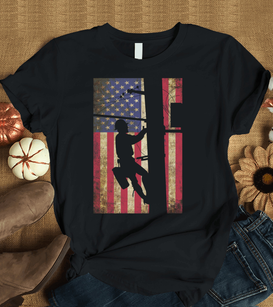 Lineman Climbing Electric Pole Against American Flag Background T-Shirt