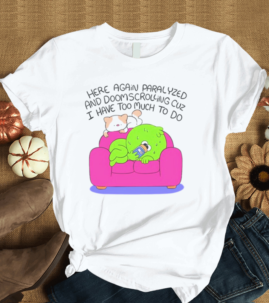 Here Again Paralyzed And Doomscrolling Cuz I Have Too Much To Do Quirky Green Figure Relaxing on Pink Couch with Cute Dog T-Shirt