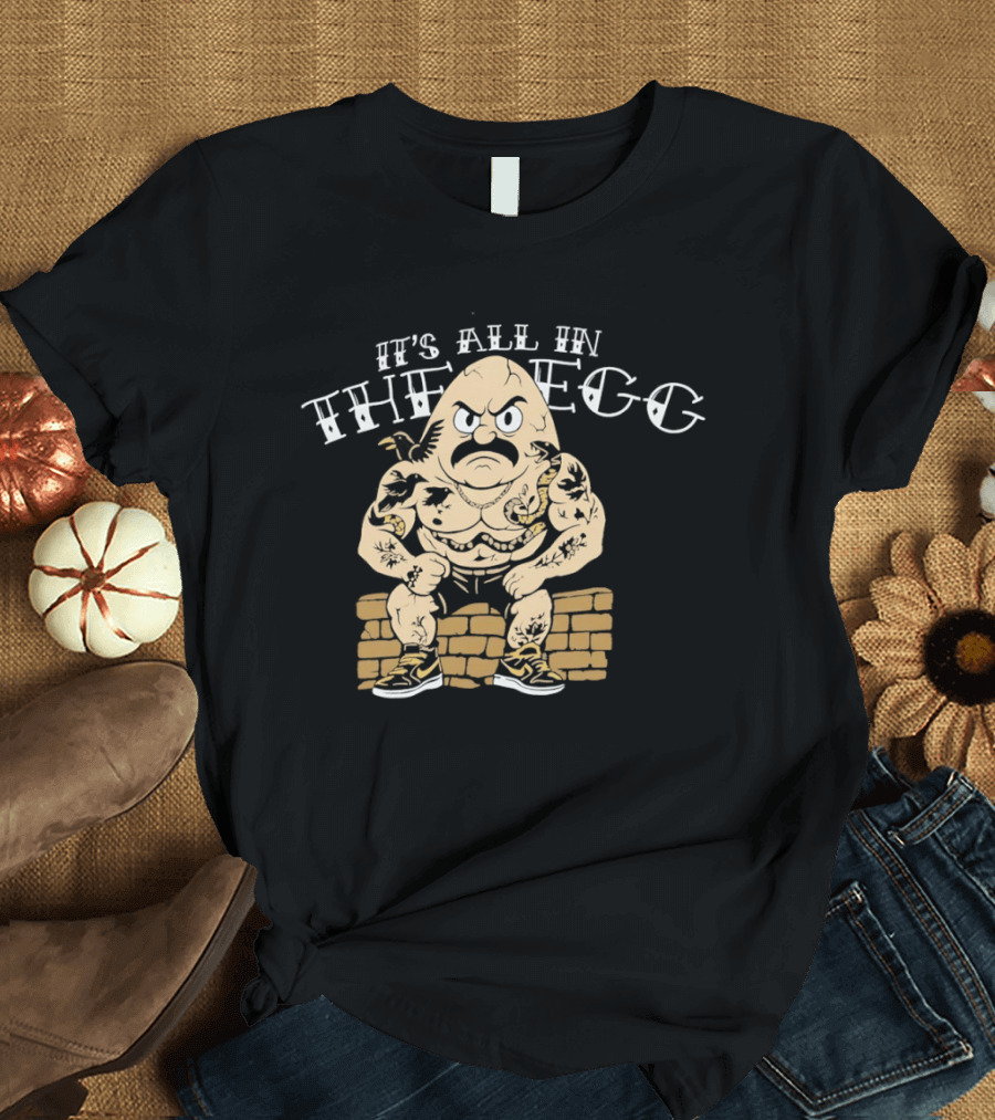 It's All In The Egg Muscular Cartoon Character With Mustache Sitting On Brick Wall T-Shirt