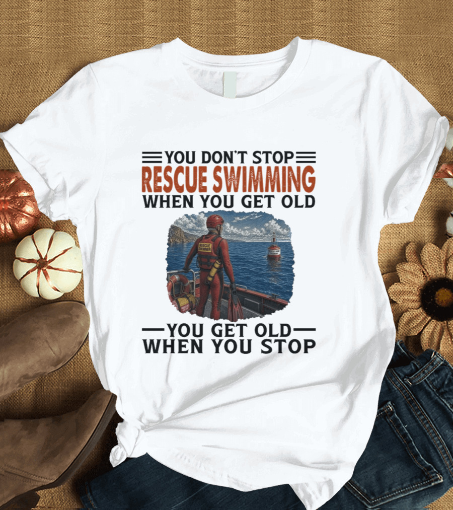 You Don't Stop Rescue Swimming When You Get Old You Get Old When You Stop Rescue Swimmer Standing On Boat Near Lighthouse T-Shirt