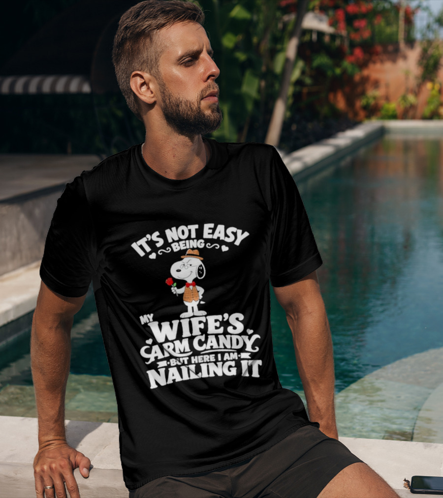 Snoopy It's Not Easy Being My Wife's Arm Candy But Here I Am Nailing It T-Shirt