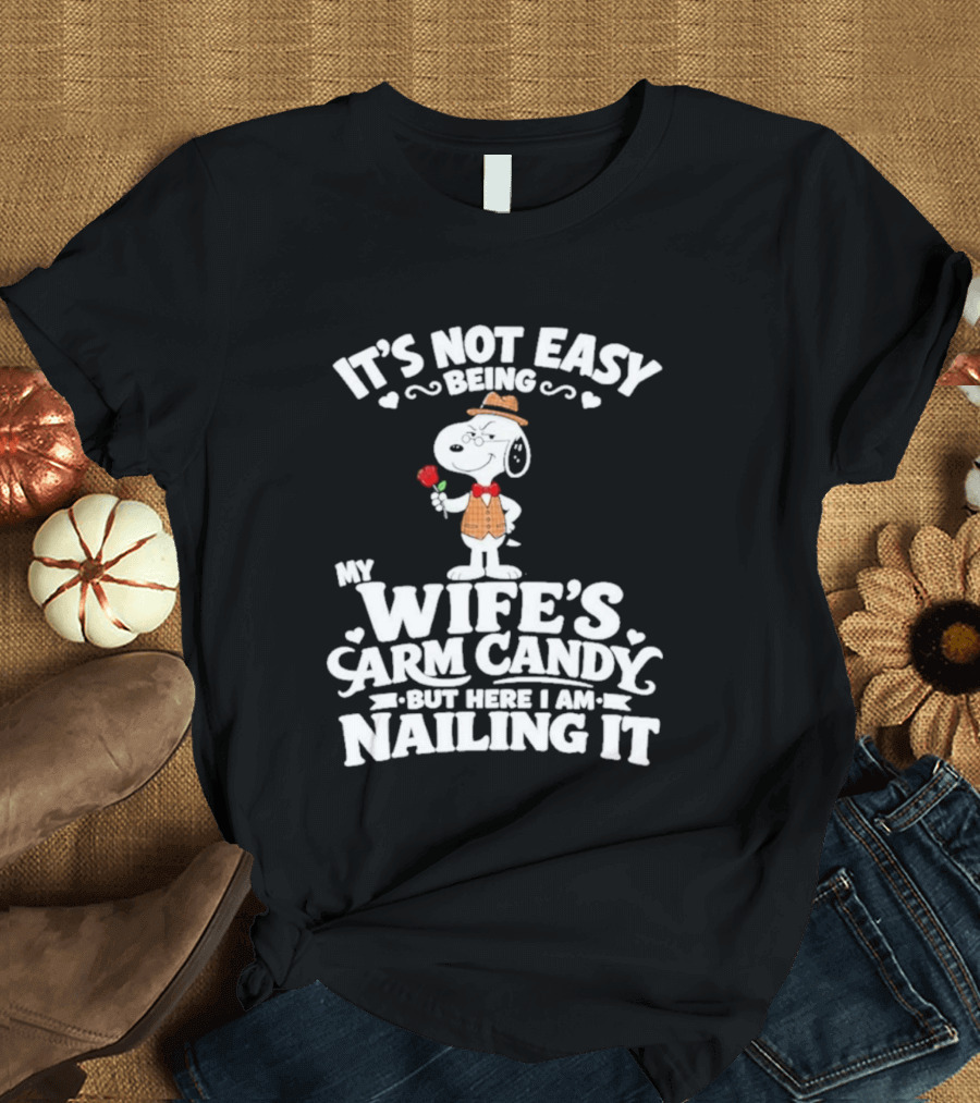 Snoopy It's Not Easy Being My Wife's Arm Candy But Here I Am Nailing It T-Shirt