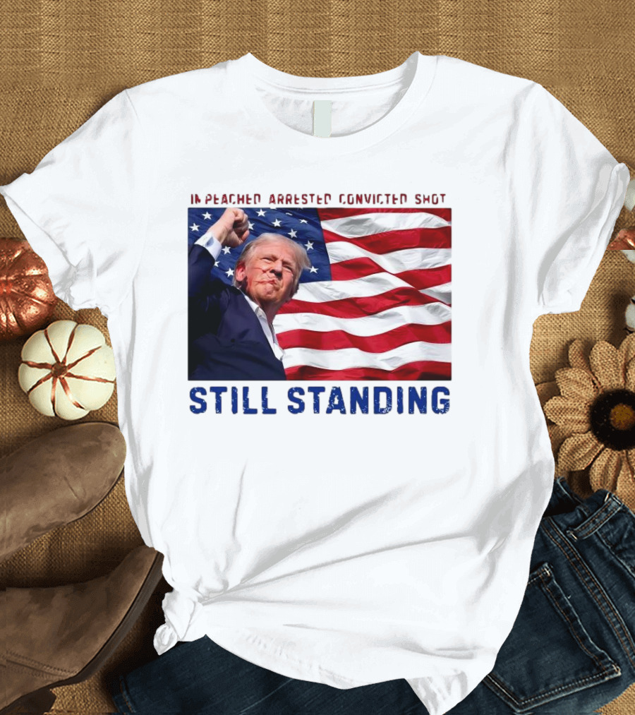 Still Standing Trump Impeached Arrested Convicted Shot American Flag Background T-Shirt