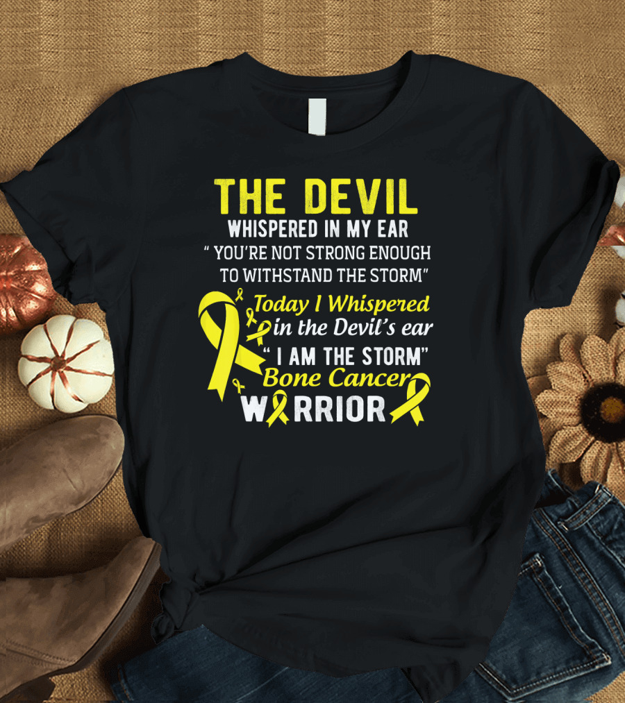 The Devil Whispered You’re Not Strong Enough To Withstand The Storm I Am The Storm Bone Cancer Warrior Yellow T-Shirt