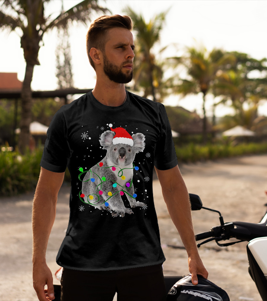 Koala Wrapped In Christmas Lights Wearing Santa Hat With Snowflakes Matching Fam T-Shirt