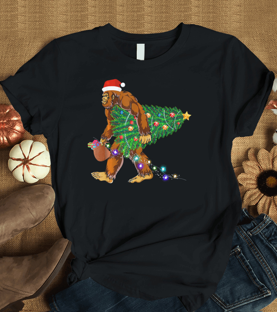 Santa Hat Bigfoot Holding Christmas Tree with Lights and Gifts T-Shirt